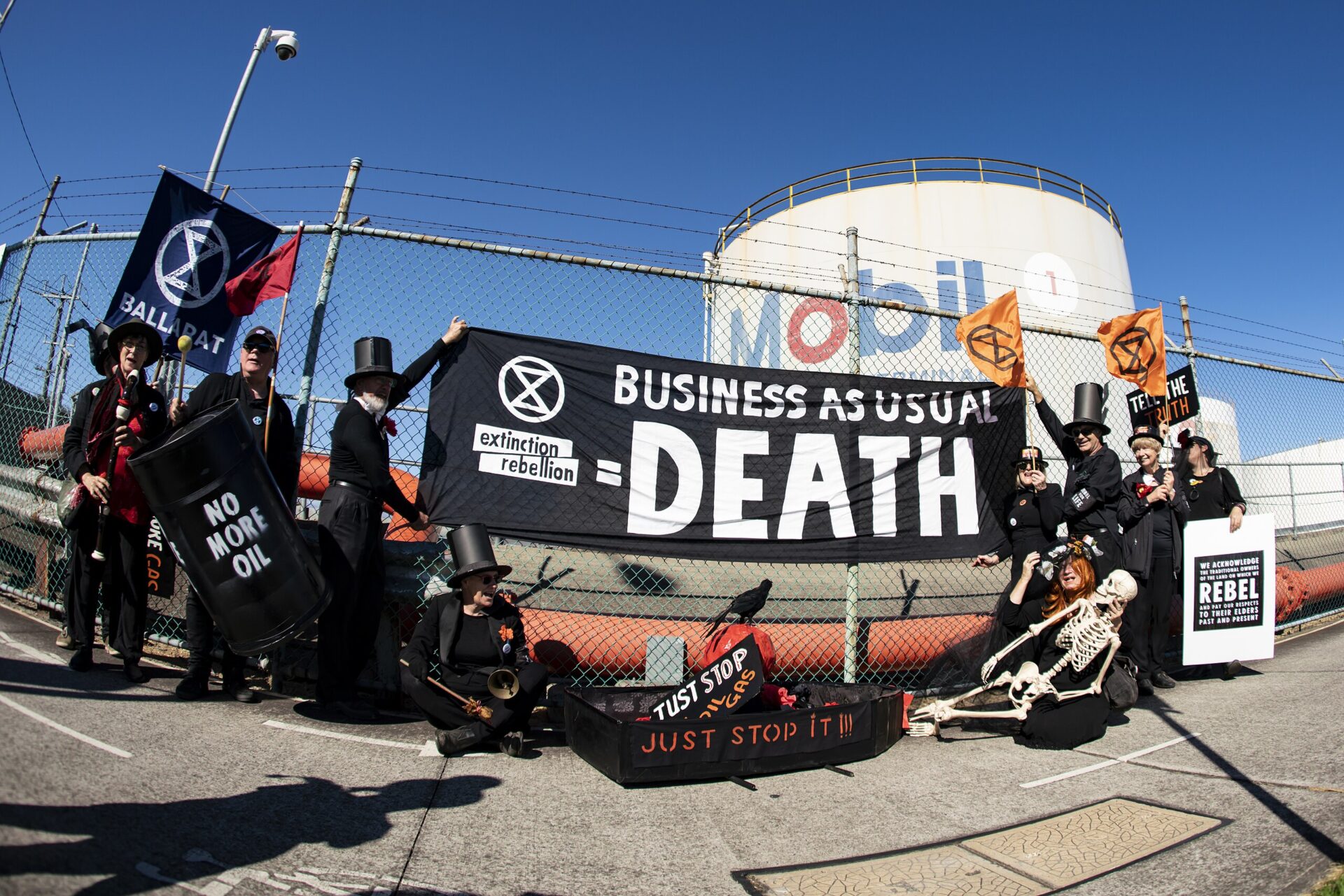Extinction Rebellion stages a funeral precession at an ExxonMobil fuel terminal